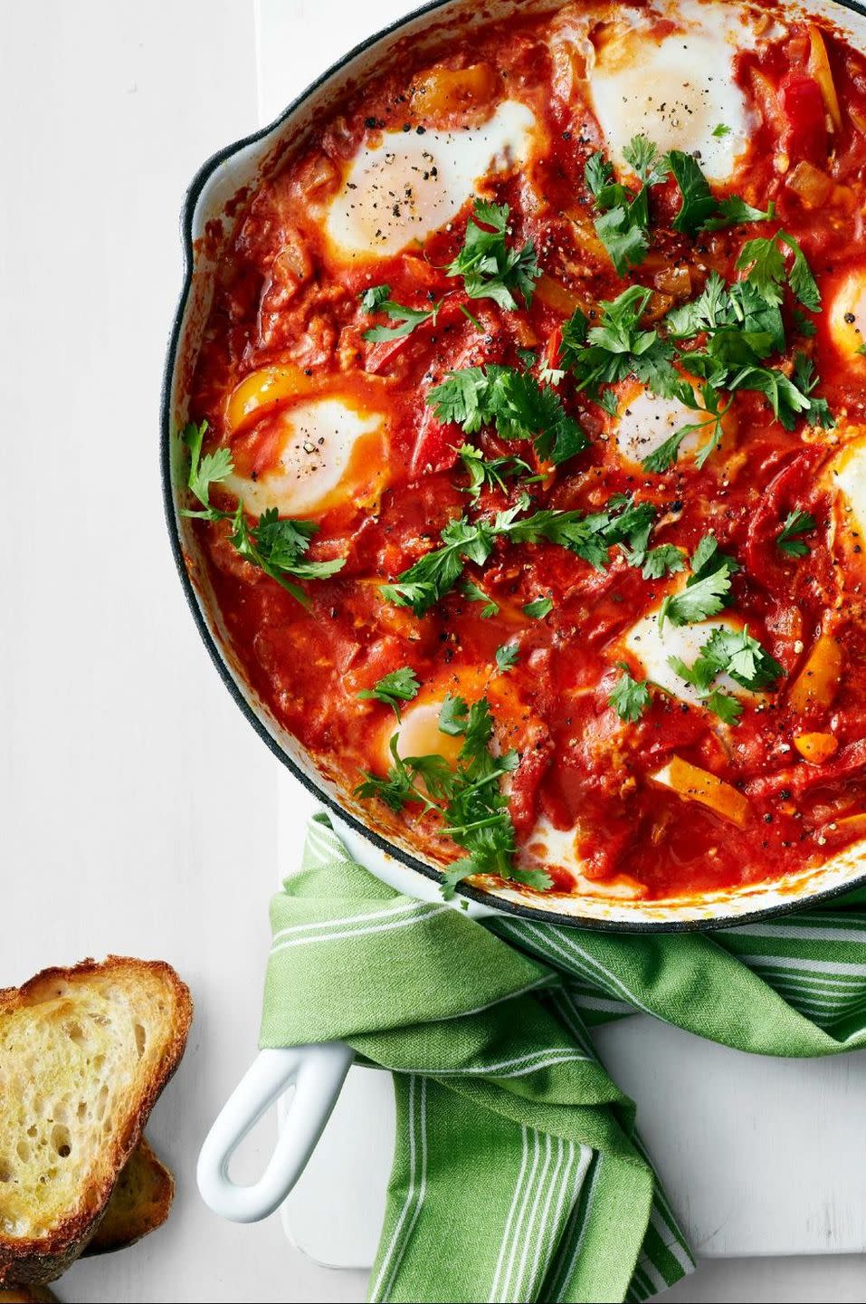 breakfast in bed stewed peppers and tomatoes with eggs in skillet