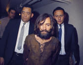 <p>Charles Manson is escorted to his arraignment on conspiracy-murder charges in connection with the Sharon Tate murder case, 1969, in Los Angeles. (Photo: AP) </p>