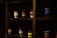 In this March 20, 2017 photo mates are seen on a shelf as people have dinner at a restaurant during an activity called "The Argentine Experience" in Buenos Aires, Argentina. Tourists participating in "The Argentine Experience" have the chance to learn about the local cuisine, wine and traditions during a dinner in Buenos Aires. (AP Photo/Natacha Pisarenko)