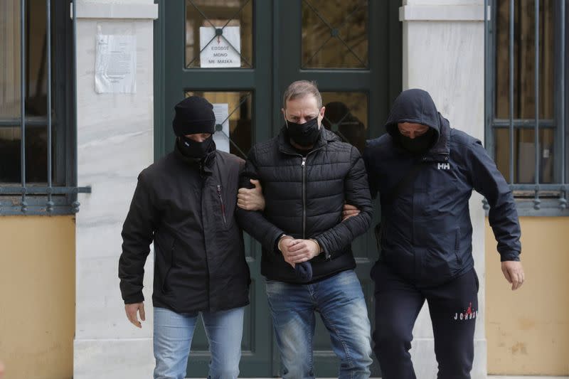 Greek actor and former director of Greece's National Theatre Lignadis is escorted by police officers as he leaves the prosecutor's office , in Athens