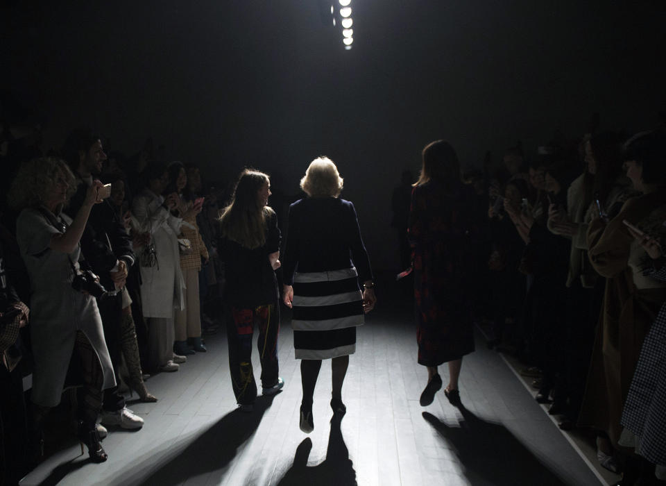 FILE - Britain's Camilla, the Duchess of Cornwall, centre walks on the runway, during London Fashion Week after presenting the Queen Elizabeth II Award for Design on behalf of the Queen, in London, Tuesday, Feb. 19, 2019. (Eddie Mulholland/Pool Photo via AP, File)