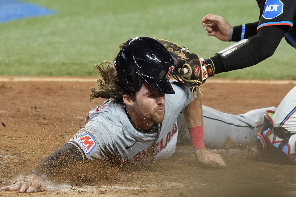 Cleveland Guardians' Daniel Schneemann is tagged out at the plate during the eighth inning of the team's baseball game against the Miami Marlins, Friday, June 7, 2024, in Miami. (AP Photo/Lynne Sladky)