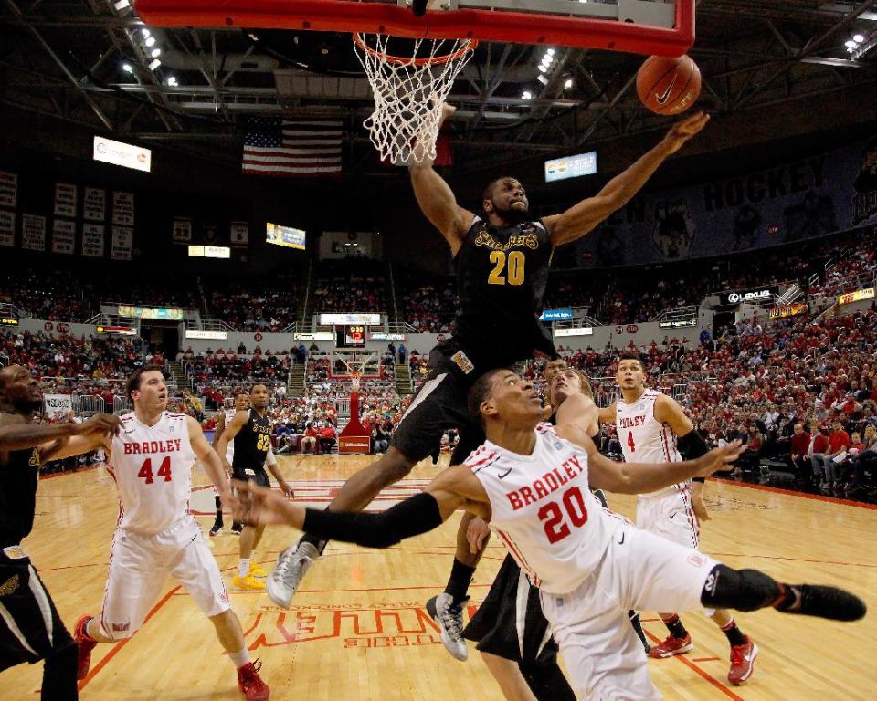 Wichita State center Kadeem Coleby (20) blocks a layup from Bradley forward Tyshon Pickett (20) during the first half of an NCAA college basketball game at Carver Arena Tuesday, Feb. 25, 2014, in Peoria, Ill. Wichita State won the game 69-49. (AP Photo/ Stephen Haas)