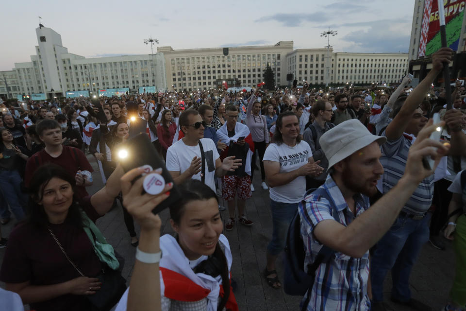 Protesters lights their smartphones during an opposition rally at Independent Square in Minsk, Belarus, Monday, Aug. 24, 2020. Belarusian authorities on Monday detained three leading opposition activists who have helped spearhead a wave of protests demanding the resignation of the country's authoritarian president Alexander Lukashenko following a disputed election. (AP Photo/Sergei Grits)