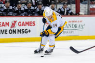 Nashville Predators center Gustav Nyquist (14) skates with the puck during the first period of an NHL hockey game against the New Jersey Devils in Newark, N.J., Sunday, April 7, 2024. (AP Photo/Peter K. Afriyie)