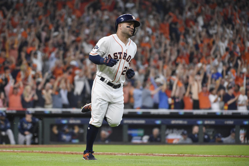 Houston Astros' Jose Altuve (27) rounds the bases after hitting a two-run home run against the Tampa Bay Rays in the fifth inning during Game 1 in baseball's American League Division Series in Houston, Friday, Oct. 4, 2019. (AP Photo/Michael Wyke)