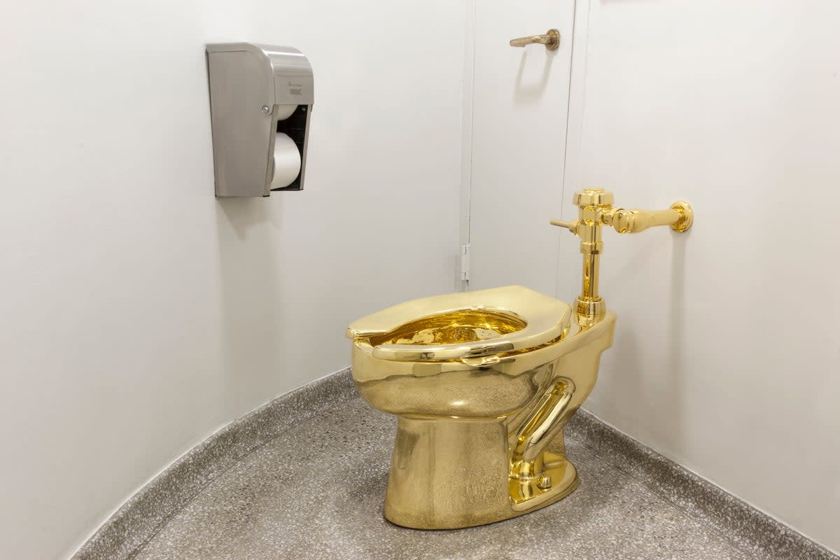 The fully functioning toilet, titled ‘America’, was created by Italian artist Maurizio Cattelan and housed in the Oxfordshire country house where Winston Churchill was born (PA)