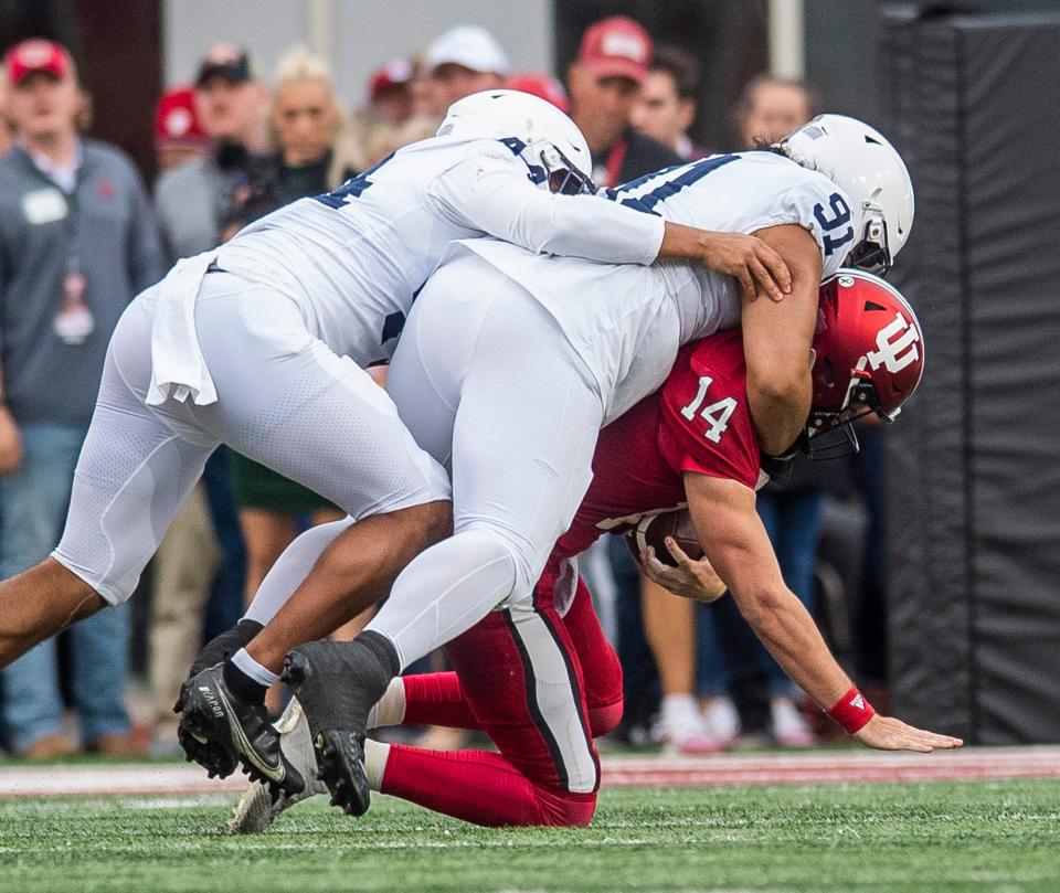 Indiana's Jack Tuttle (14) is sacked by Penn State's Dvon Ellies (91) during the first half of the Indiana versus Penn State football game at Memorial Stadium on Satruday, Nov. 5, 2022.