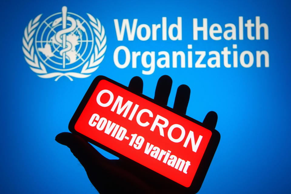 UKRAINE - 2021/11/26: In this photo illustration, words that say Omicron COVID-19 variant is seen on a mobile phone screen in front of the WHO (World Health Organization) logo in the background. (Photo Illustration by Pavlo Gonchar/SOPA Images/LightRocket via Getty Images)