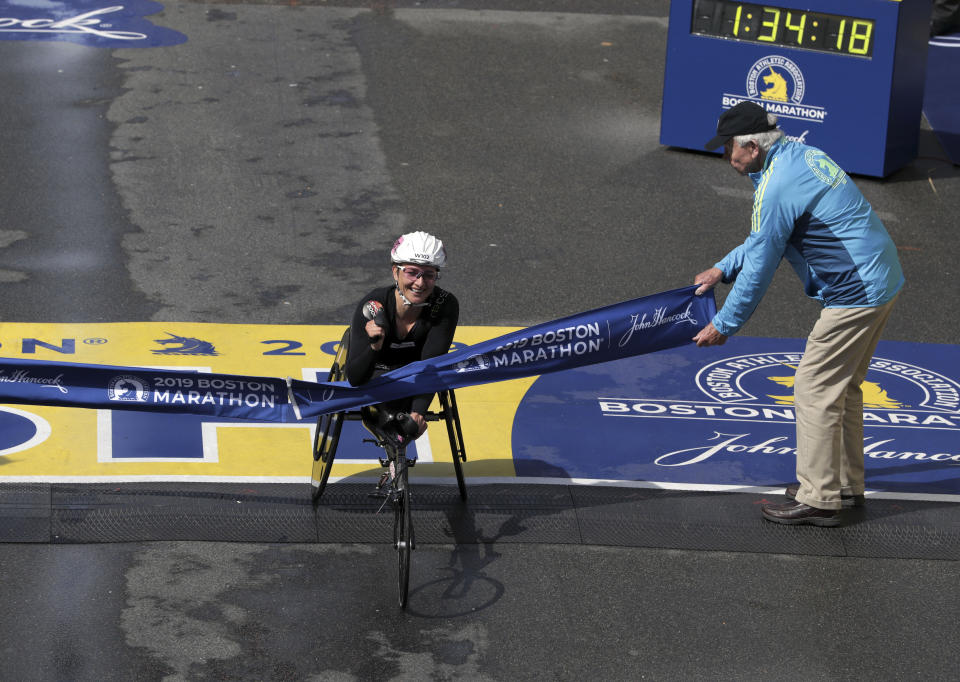 Manuela Schar, of Switzerland, breaks the tape to win the women's handcycle division of the 123rd Boston Marathon on Monday, April 15, 2019, in Boston. (AP Photo/Charles Krupa)