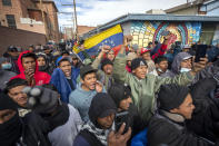 Migrants, mostly from Venezuela, chant slogans as an activists' march in their support arrives to downtown El Paso, Texas, Saturday, Jan. 7, 2023. Several hundred marched through the streets of El Paso a day before President Joe Biden's first, politically-thorny visit to the southern border. (AP Photo/Andres Leighton)