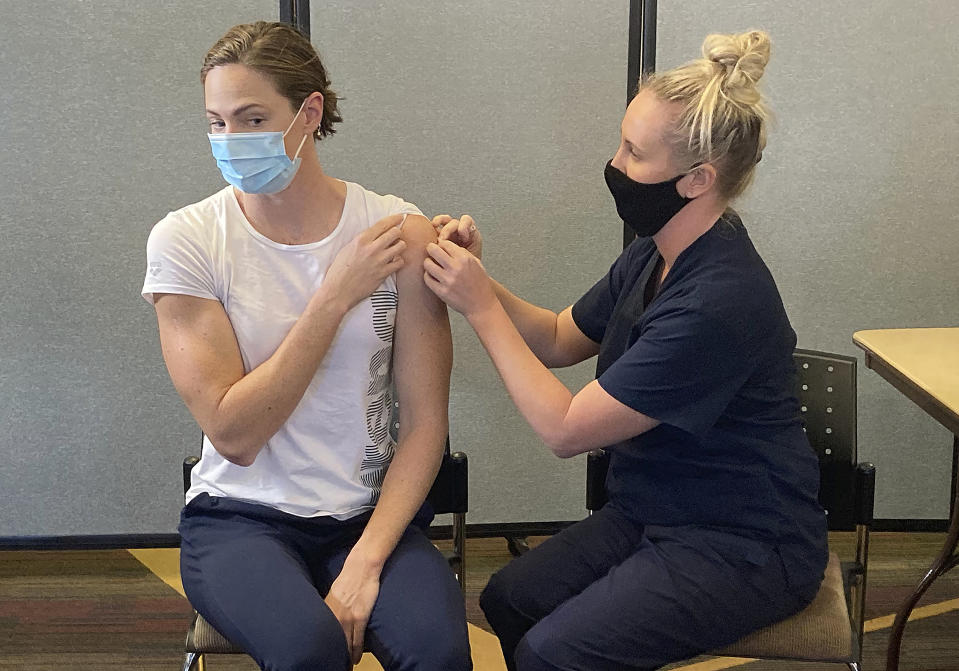 Swimmer Cate Campbell receives a Pfizer COVID-19 vaccination at the Queensland Academy of Sport in Brisbane, Australia, Monday, May 10, 2021. The Australian government announced after a special National Cabinet meeting that Olympic participants would be vaccinated under a priority group which includes health-care workers, Indigenous people aged over 55 and people older than 70. (AP Photo/John Pye)