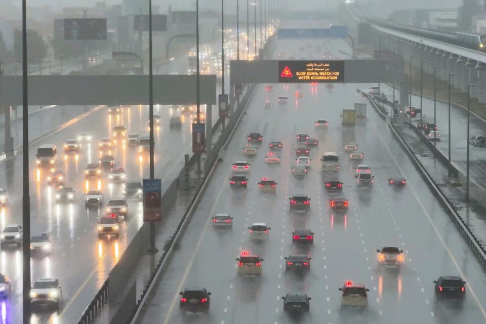 Vehicles drive through heavy rain on the Sheikh Zayed Road highway in Dubai, United Arab Emirates, Tuesday, April 16, 2024 (AP)