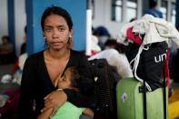 The Wider Image: Venezuelan mothers, children in tow, rush to migrate