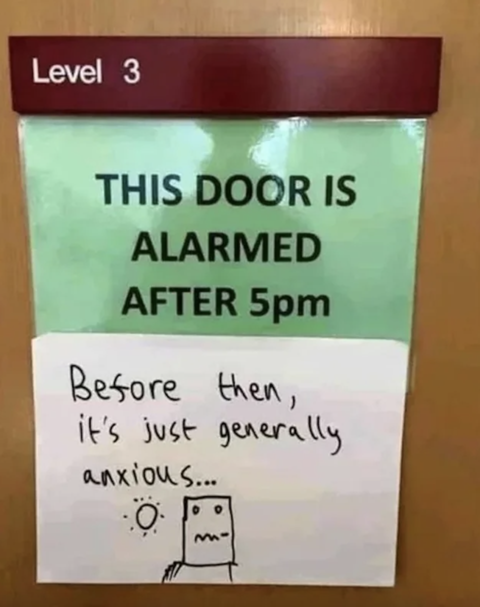 Sign on a door: "This door is alarmed after 5 pm"; handwritten below it: "Before then, it's just generally anxious"