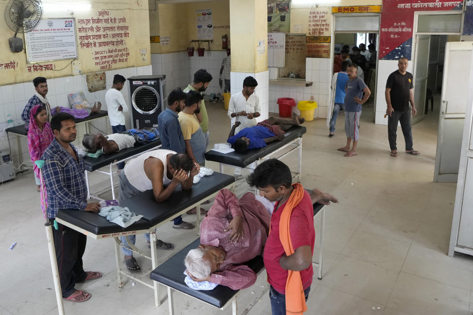 People suffering from heat related ailments crowd the district hospital in Ballia, Uttar Pradesh state, India, Monday, June 19, 2023. Several people have died in two of India's most populous states in recent days amid a searing heat wave, as hospitals find themselves overwhelmed with patients. More than hundred people in the Uttar Pradesh state, and dozens in neighboring Bihar state have died due to heat-related illness. (AP Photo/Rajesh Kumar Singh)