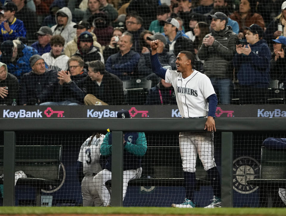 Seattle Mariners' Julio Rodriguez cheers from the dugout after Cal Raleigh hit an RBI single against the Los Angeles Angels during the seventh inning of a baseball game Tuesday, April 4, 2023, in Seattle. The Mariners won 11-2. (AP Photo/Lindsey Wasson)