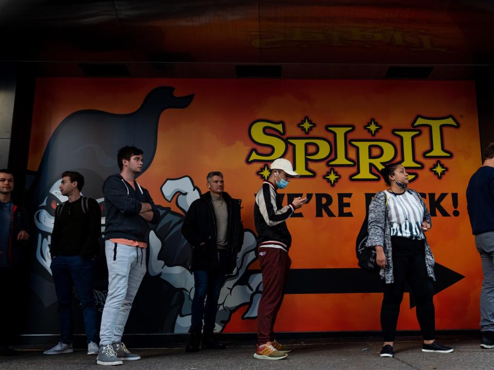 People wait in line outside a Spirit Halloween store