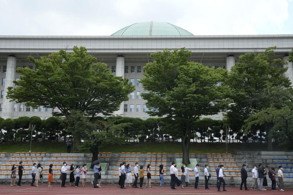 People queue in line to wait for the coronavirus testing at a makeshift testing site at the National Assembly in Seoul, South Korea, Thursday, July 15, 2021. South Korea has added 1,600 more coronavirus cases, with infections spreading beyond the hard-hit capital area where officials have enforced the country's toughest social distancing restrictions. (AP Photo/Ahn Young-joon)