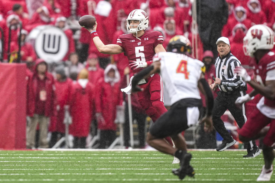 Wisconsin quarterback Graham Mertz (5) passes as Maryland defensive back Tarheeb Still (4) defends during the first half of an NCAA college football game Saturday, Nov. 5, 2022, in Madison, Wis. (AP Photo/Andy Manis)