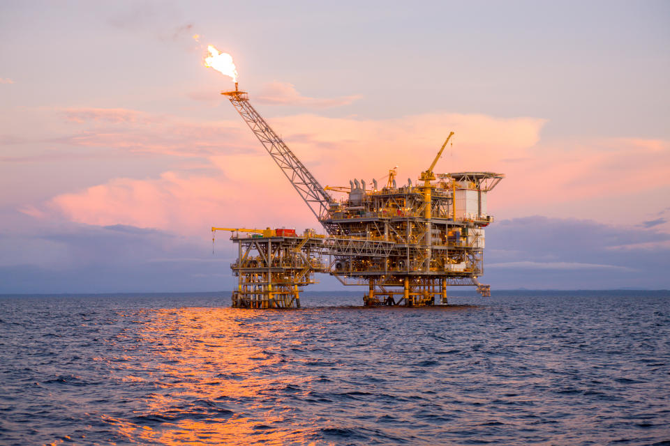 Offshore platform in sea against sky during sunset oil prices