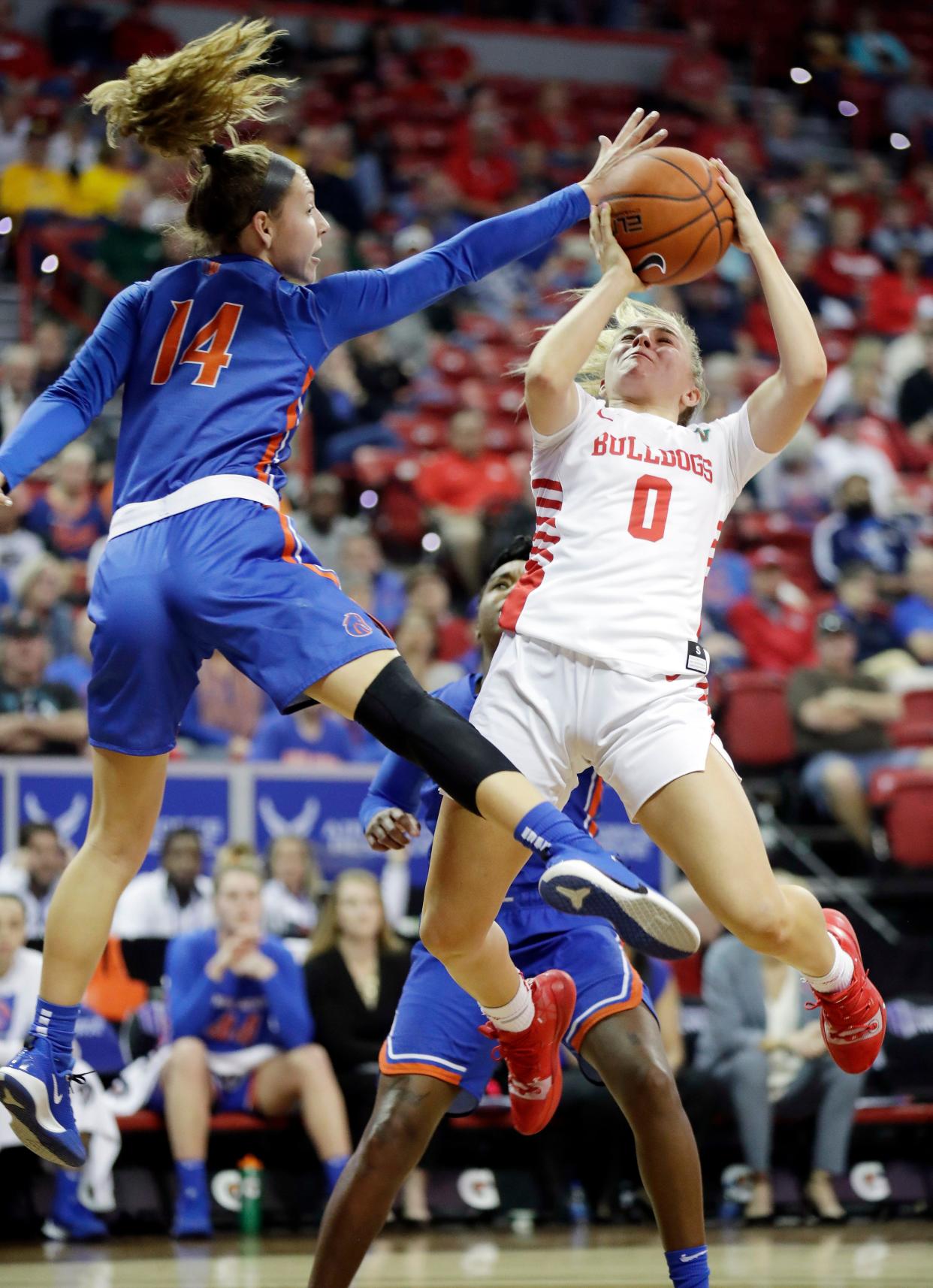 Fresno State's Hanna Cavinder (0) shoots as Boise State's Braydey Hodgins defends during the first half of an NCAA college basketball game for the Mountain West Conference women's tournament title Wednesday, March 4, 2020, in Las Vegas. (AP Photo/Isaac Brekken)