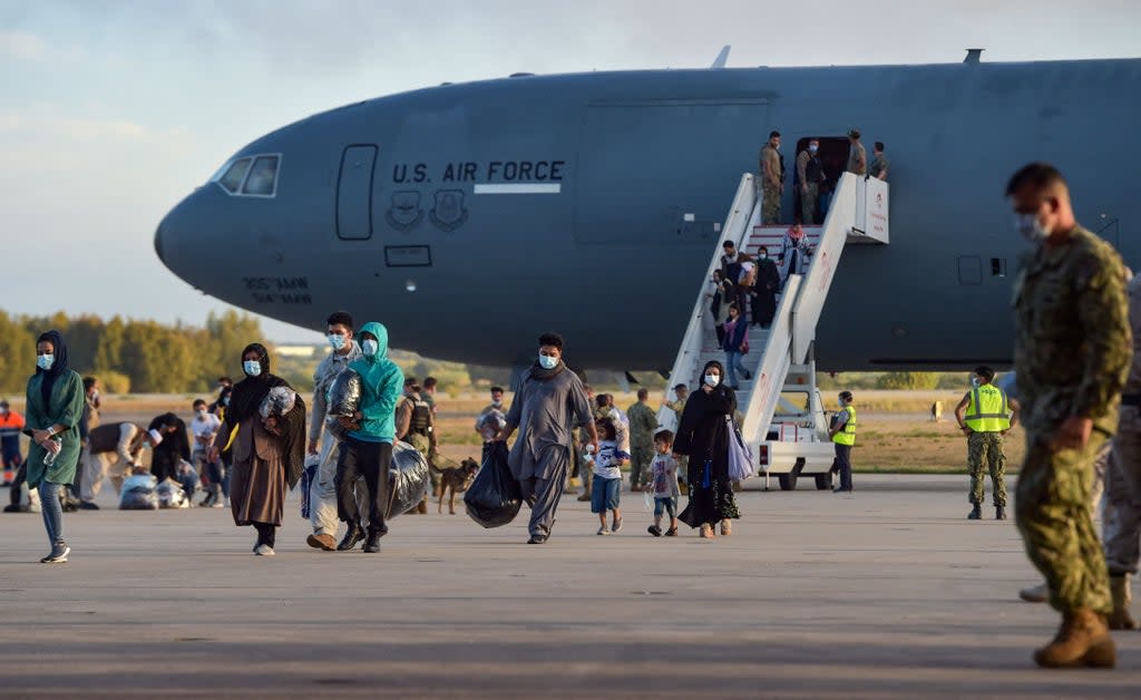 Refugees disembark from a US air force aircraft after an evacuation flight from Kabul at the Rota naval base in Rota, southern Spain, on 31 August 2021. - Japan was heavily criticised for evacuating just one passenger on its C-130 aircraft. (AFP via Getty Images)