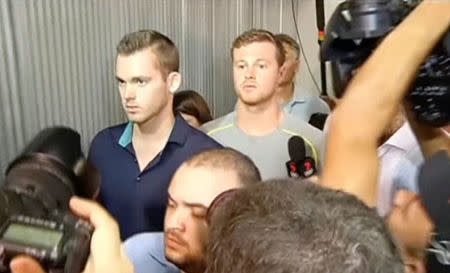 U.S. swimmers Jack Conger and Gunnar Bentz walk out of Rio de Janeiro's international airport after they were stopped from boarding a flight. TV Bandeirantes/Handout via REUTERS