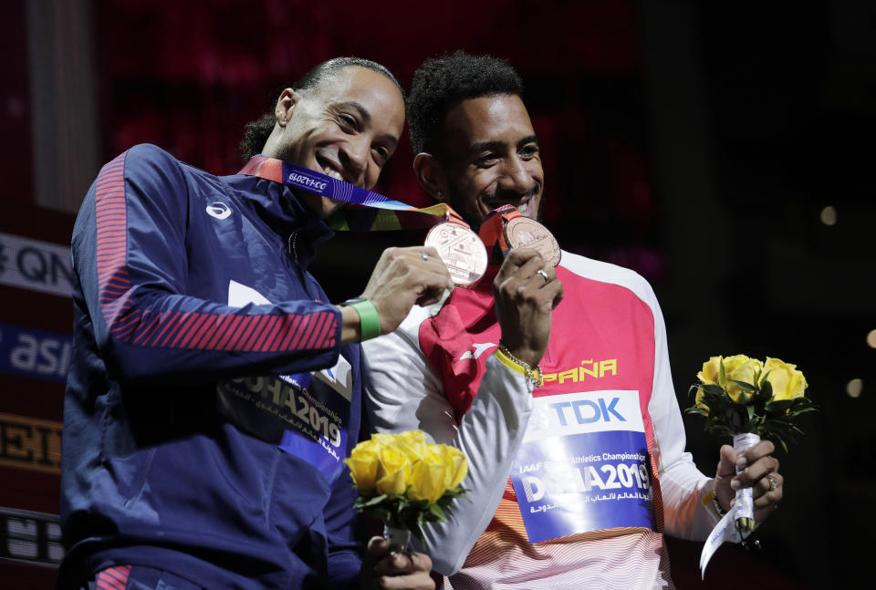Joint bronze medalists Orlando Ortega, of Spain, right, and Pascal Martinot-Lagarde, of France, smile during the award ceremony for the men's 110 meter hurdles at the World Athletics Championships in Doha, Qatar, Thursday, Oct. 3, 2019. (AP Photo/Nariman El-Mofty)