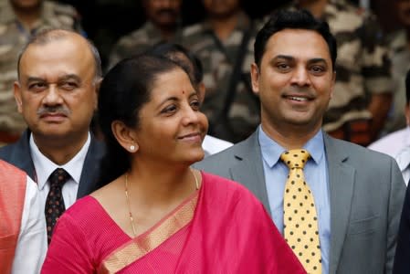 FILE PHOTO: India's Finance Minister Nirmala Sitharaman (C) and Krishnamurthy Subramanian (R), chief economic adviser, pose outside their office before the presentation of the federal budget