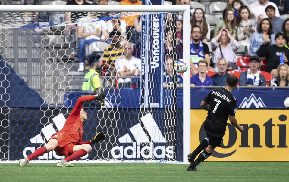 Minnesota United's Franco Fragapane (7) scores against Vancouver Whitecaps goalkeeper Cody Cropper during the second half of an MLS soccer match Friday, July 8, 2022, in Vancouver, British Columbia. (Darryl Dyck/The Canadian Press via AP)