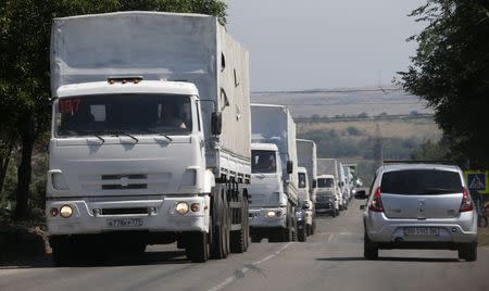 Trucks of a Russian convoy carrying humanitarian aid for Ukraine, drive in the direction of the Ukrainian border near the town of Donetsk, in Russia's Rostov Region, August 22, 2014. REUTERS/Alexander Demianchuk