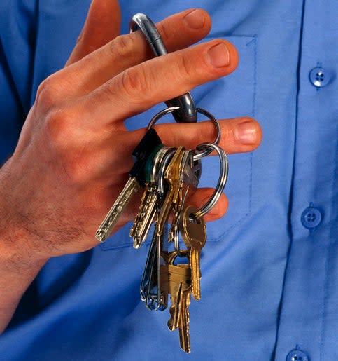 Person holding a ring of keys over a shirt with an embroidered tag reading "W.51st ST."