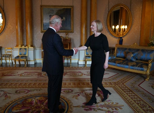 The King shakes hands with Liz Truss during their first audience at Buckingham Palace