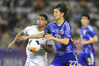 Nihad Mohammed. left, and Kota Takai run for the ball during a U-23 Asian Cup semi-final match between Iraq and Japan in Doha, Qatar, on Monday, April 29, 2024. (AP Photo/Hussein Sayed)