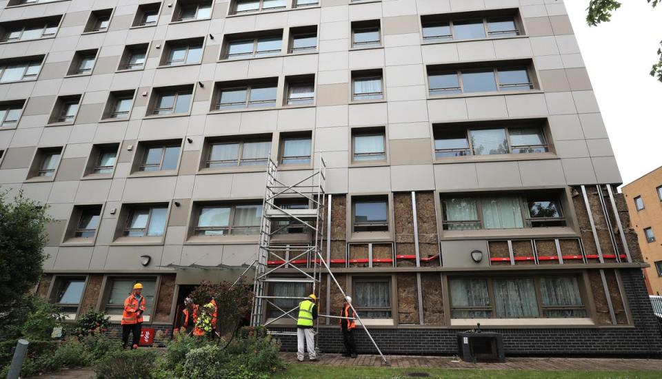 Cladding being removed from a high-rise block (Peter Byrne/PA) (PA Archive)