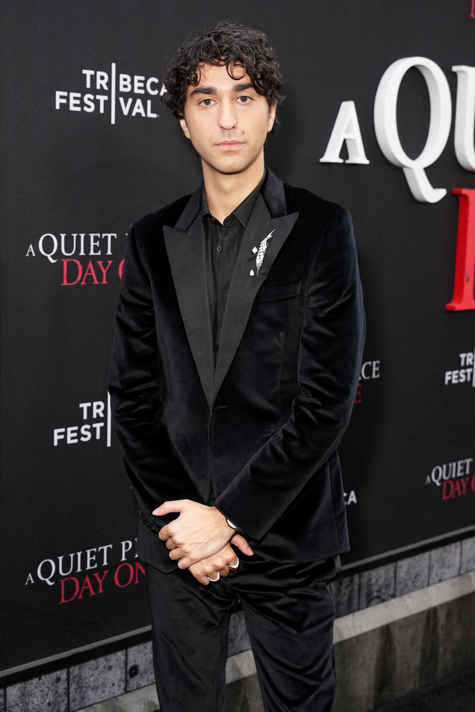 Alex Wolff at the Tribeca Festival for "A Quiet Place Day One" premiere, wearing a black velvet suit with a white floral lapel pin