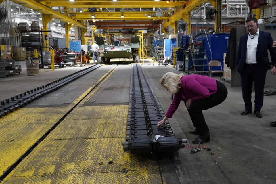 Secretary of the Army Christine Wormuth touches the tank treads of the M1A2 Abrams main battle tank during a tour of the Joint Systems Manufacturing Center, Thursday, Feb. 16, 2023, in Lima, Ohio. (AP Photo/Carlos Osorio)