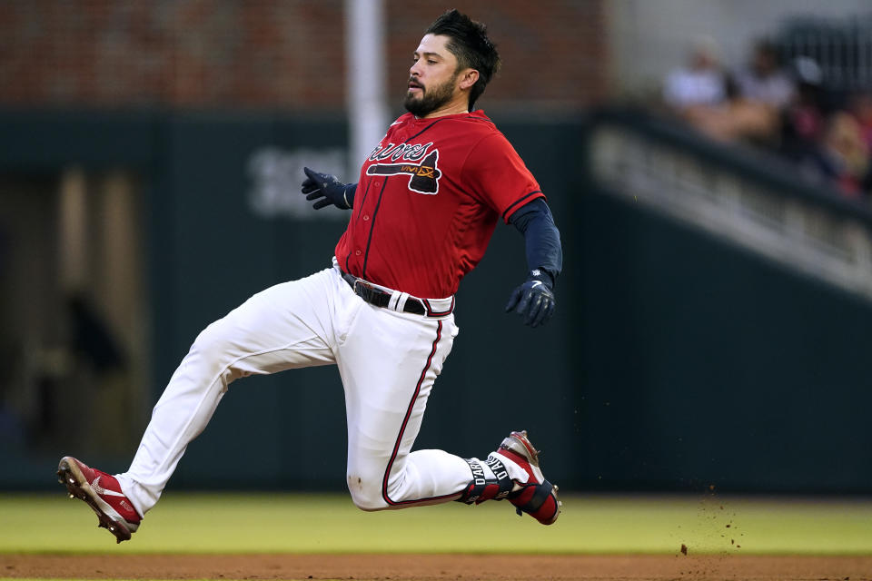 Atlanta Braves' Travis d'Arnaud (16) slides into second base with a double during the fourth inning of the team's baseball game against the Pittsburgh Pirates on Friday, June 10, 2022, in Atlanta. (AP Photo/John Bazemore)