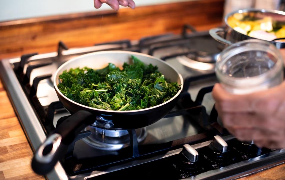 Sautéeing greens on the stovetop.