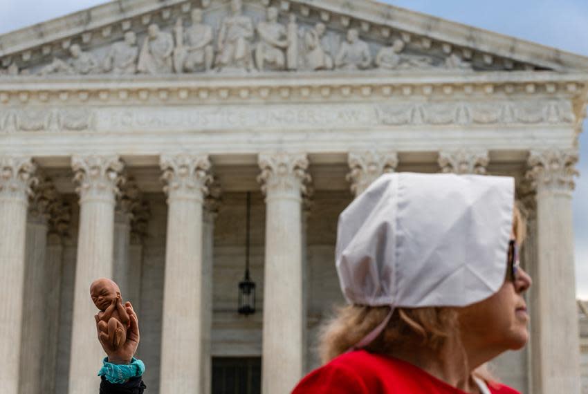 A member of the Progressive Anti-Abortion Uprising holds a prop fetus outside the Supreme Court in Washington, D.C., on Nov. 1, 2021.