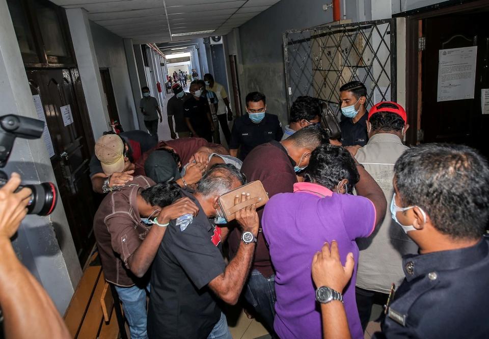 The 12 individuals arrested for gathering at a pub during the CMCO period are seen at the Magistrate Court in Ipoh June 1, 2020 — Picture by Farhan Najib
