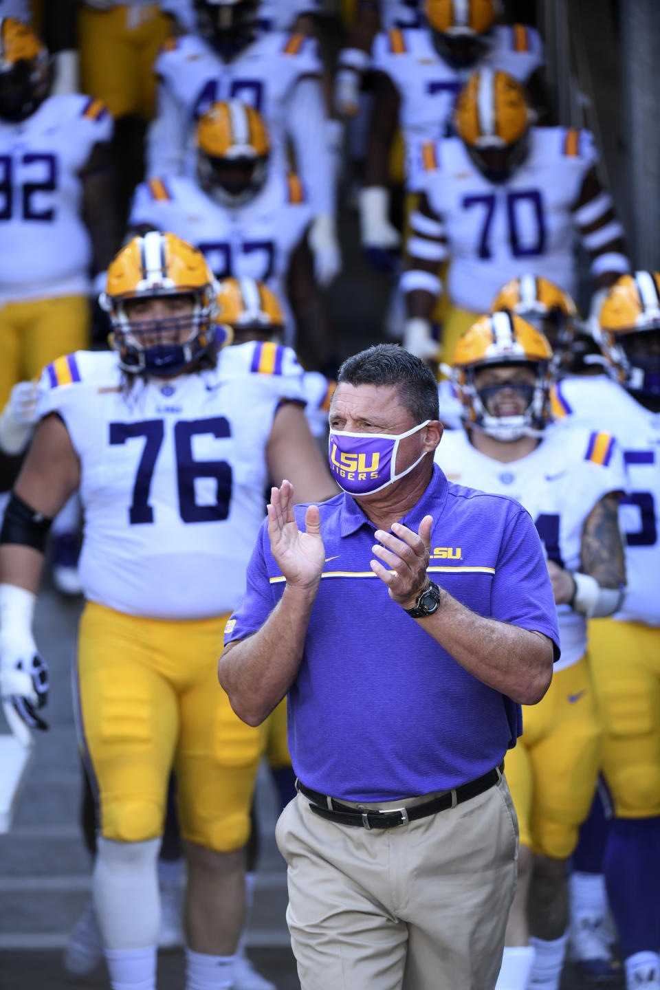 LSU head coach Ed Orgeron heads to the field with his team before the start an NCAA college football game against Missouri Saturday, Oct. 10, 2020, in Columbia, Mo. (AP Photo/L.G. Patterson)