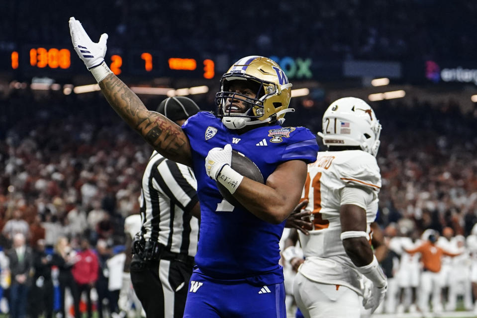 Washington running back Dillon Johnson (7) celebrates his touchdown against Texas during the first half of the Sugar Bowl CFP NCAA semifinal college football game, Monday, Jan. 1, 2024, in New Orleans. (AP Photo/Jacob Kupferman)