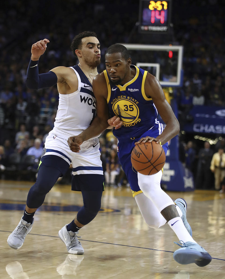 Golden State Warriors' Kevin Durant (35) drives the ball as Minnesota Timberwolves' Tyus Jones defends during the second half of an NBA basketball game Friday, Nov. 2, 2018, in Oakland, Calif. (AP Photo/Ben Margot)