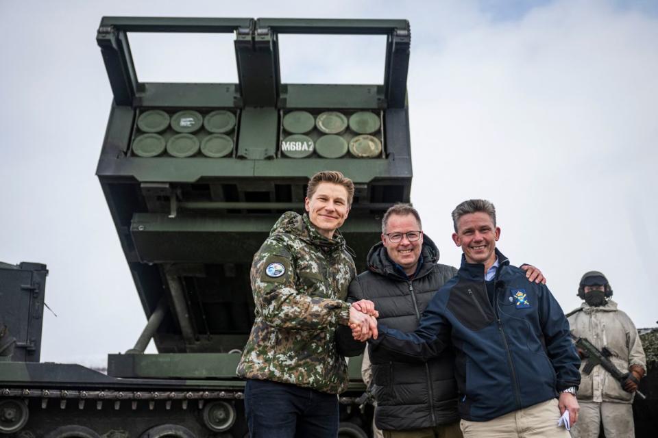 (LtoR) Finnish Defense Minister Antti Hakkanen, his Norwegian counterpart Bjorn Arild Gram, and their Swedish counterpart Pal Jonson pose and shake hands ahead of a demonstration of border crossing by Swedish and Finnish troops as part of the NATO Nordic Response 24 military exercise on March 9, 2024, on the Finnish side of the Kivilompolo border crossing between Finland and Norway, located above the Arctic Circle. (Jonathan Nackstrand /AFP via Getty Images)