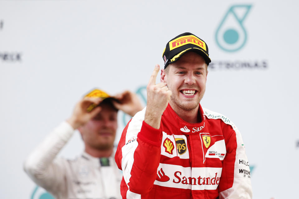 Making his point: Sebastian Vettel celebrates after winning the 2015 Malaysian Grand Prix