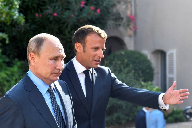 FILE PHOTO: French President Emmanuel Macron welcomes Russia's President Vladimir Putin, at his summer retreat of the Bregancon fortress on the Mediterranean coast