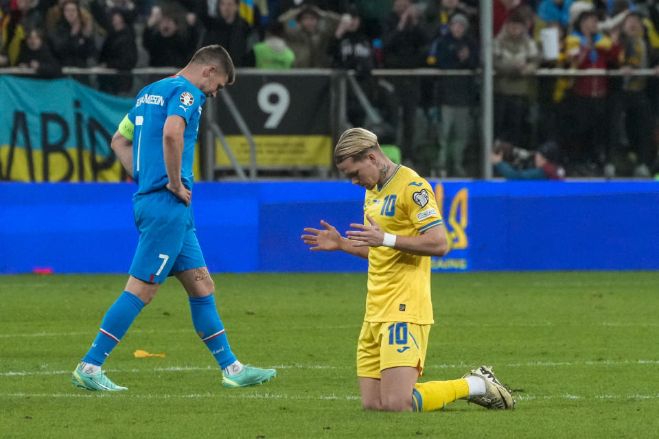 Ukraine's Mykhailo Mudryk, right, celebrates at the end of the Euro 2024 qualifying play-off soccer match between Ukraine and Iceland, at the Tarczynski Arena Wroclaw in Wroclaw, Poland, Tuesday, March 26, 2024. (AP Photo/Czarek Sokolowski)