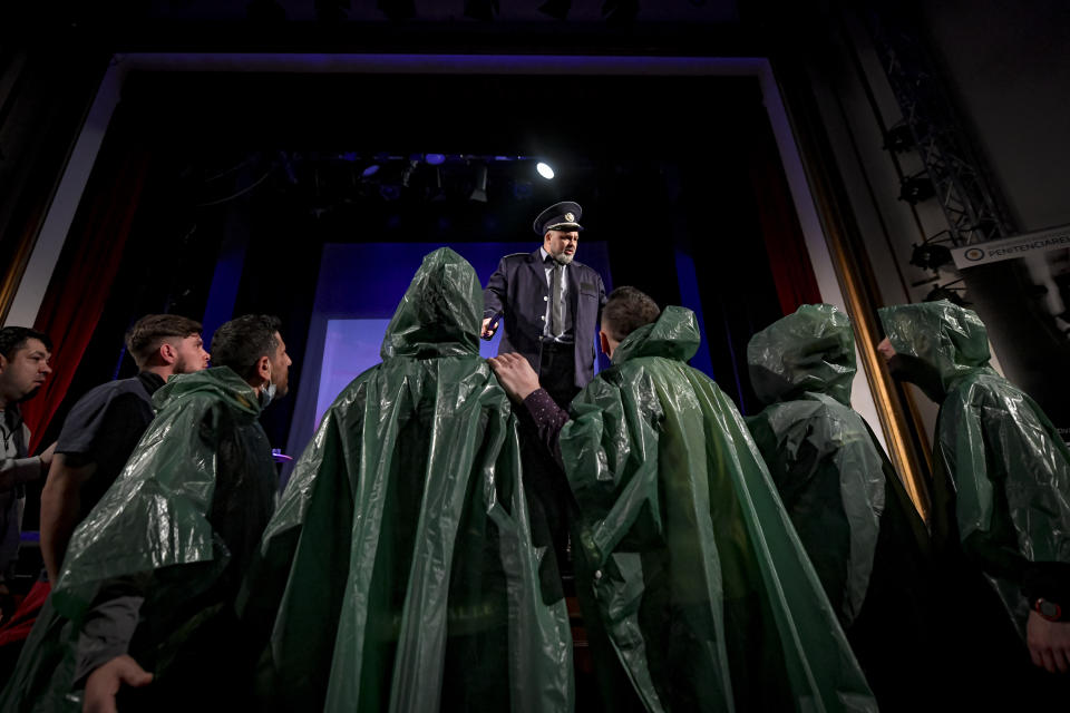 Inmates perform in the State of Siege, by French author Albert Camus, a play describing the arrival of plague in Spain which brings a totalitarian regime to power, at the Nottara Theatre in Bucharest, Romania, Wednesday, Nov. 24, 2021. (AP Photo/Andreea Alexandru)